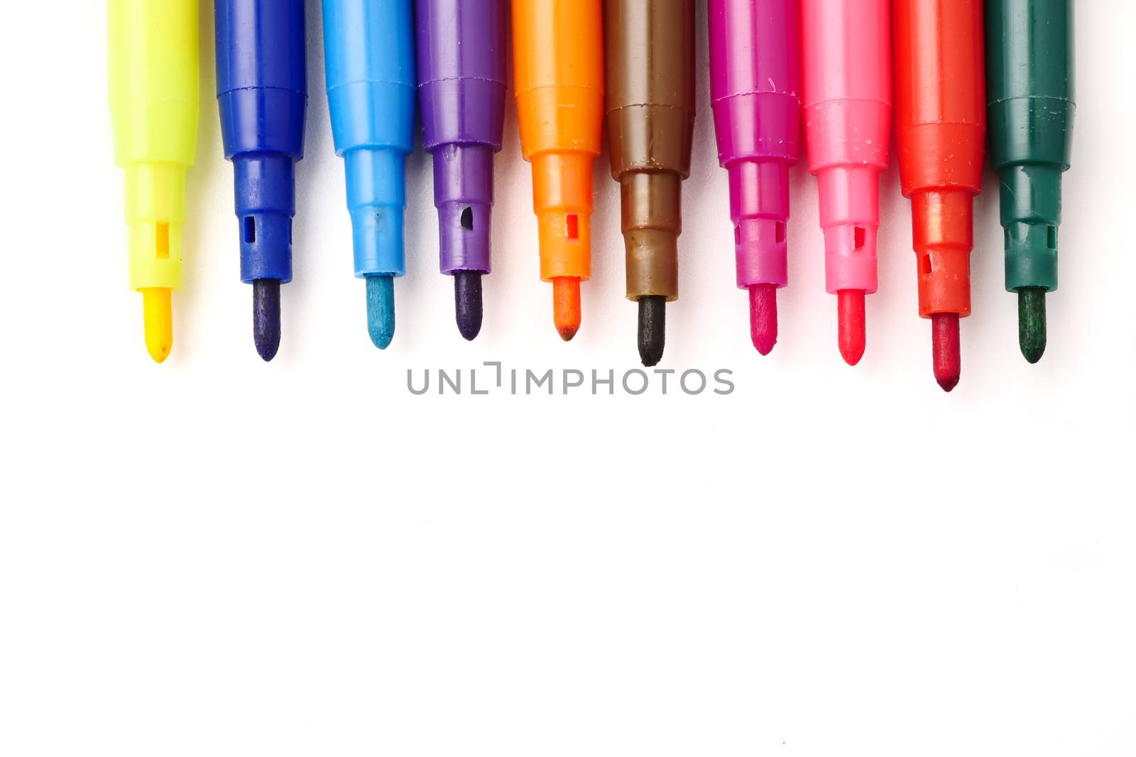 Magic colorful pens on a white background. Free space for text