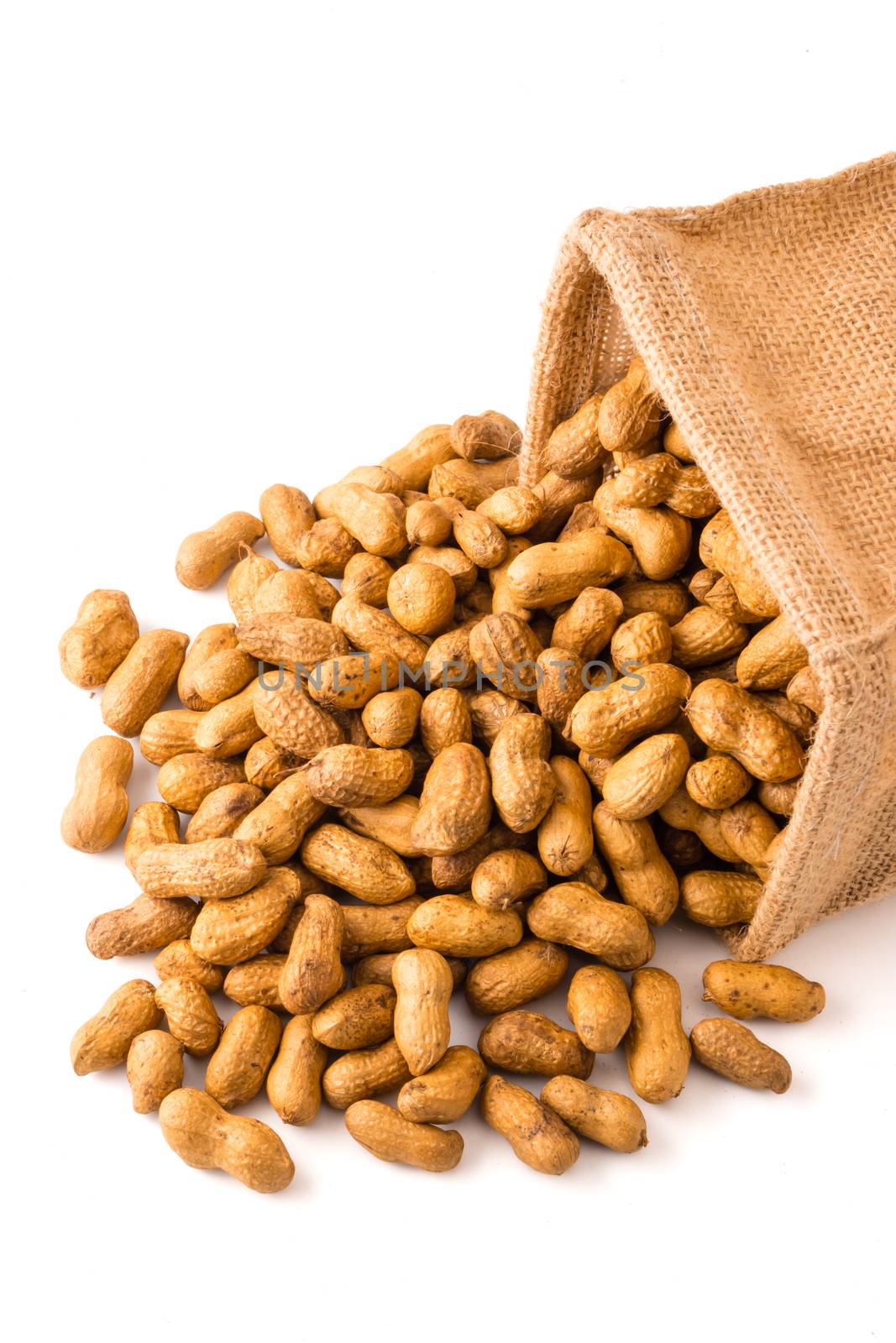 Peanuts in burlap bag on white background. by ronnarong