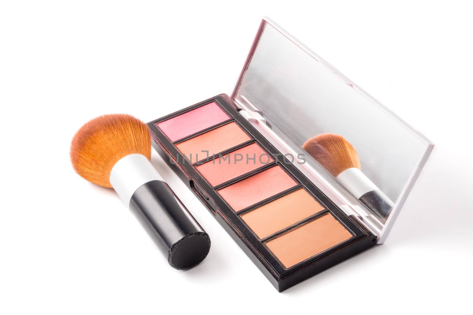 Makeup brush and palette on white background.