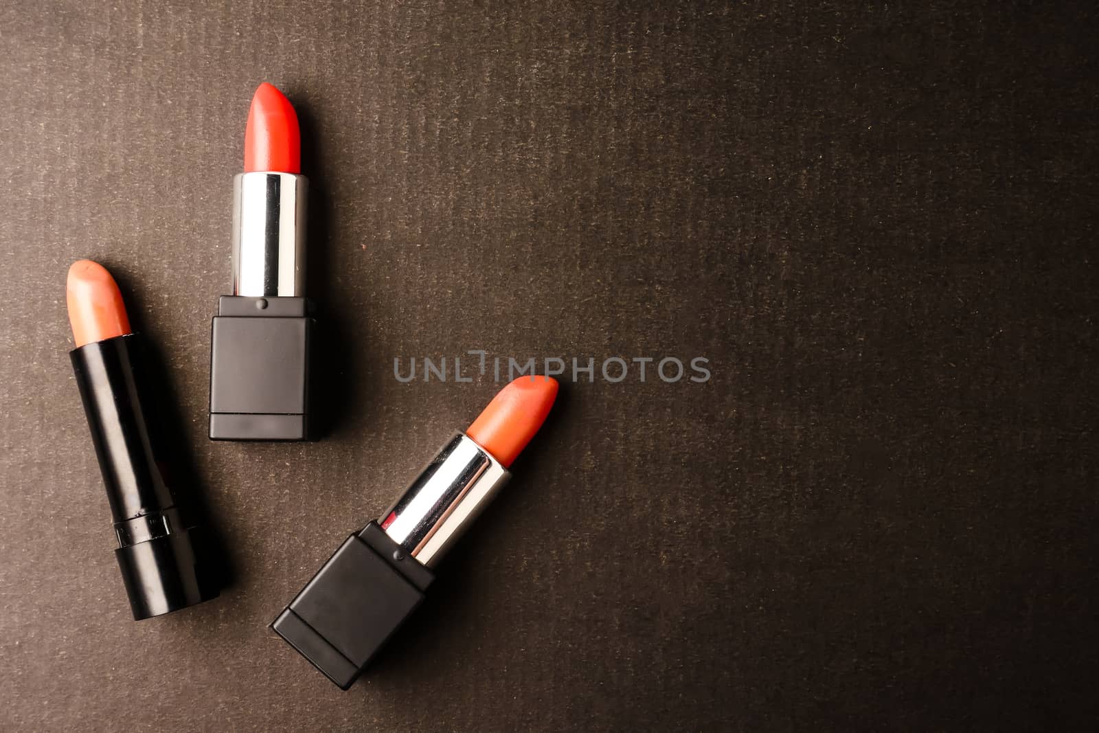 Top view of Lipsticks on black background. Free space for text