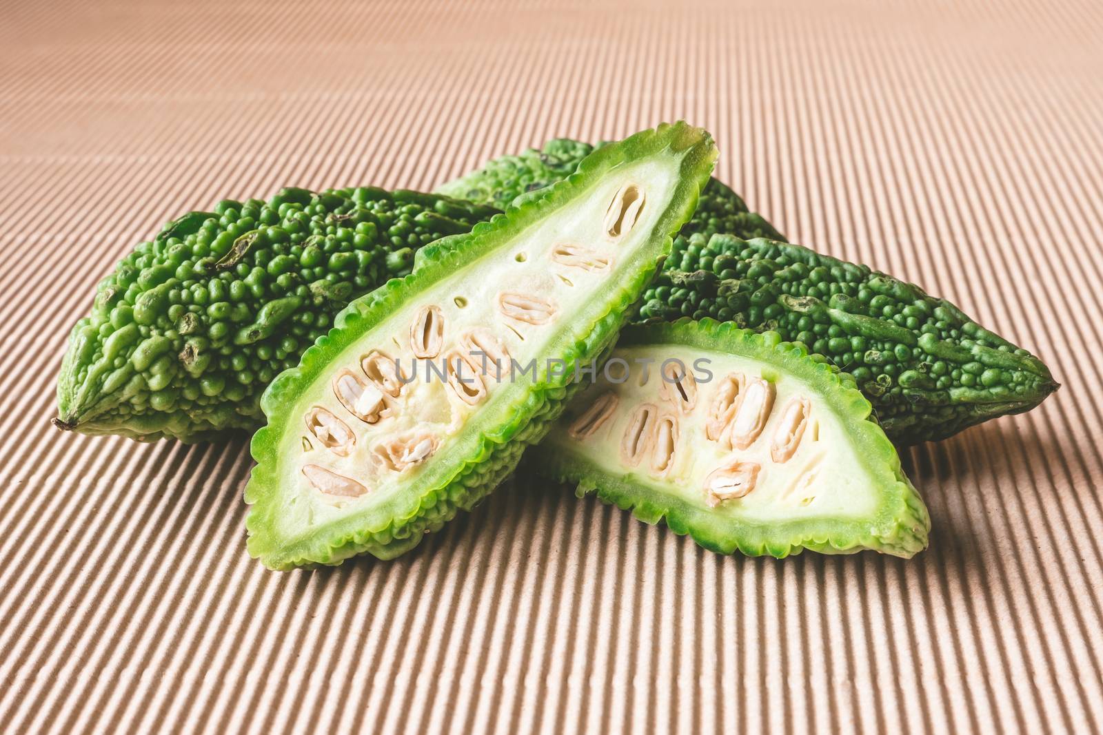 Bitter melon or bitter gourd on wooden background.