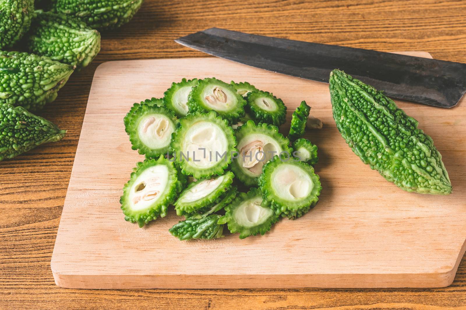 Bitter melon or bitter gourd on wooden tray.