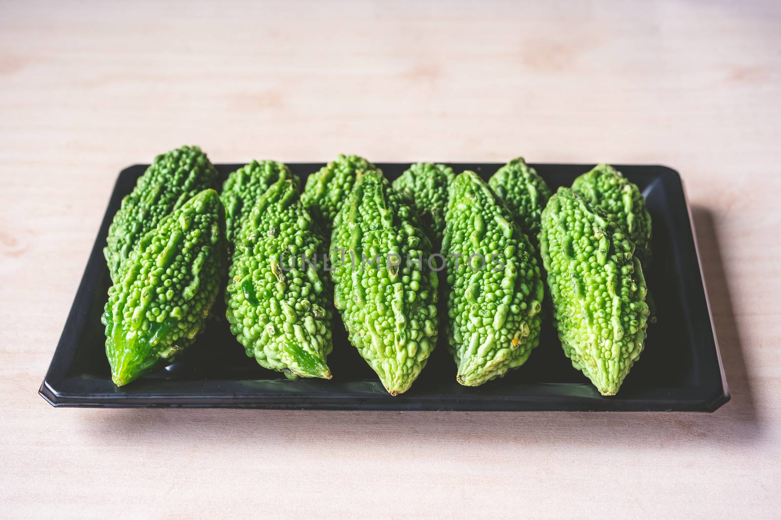 Bitter melon or bitter gourd on dish.