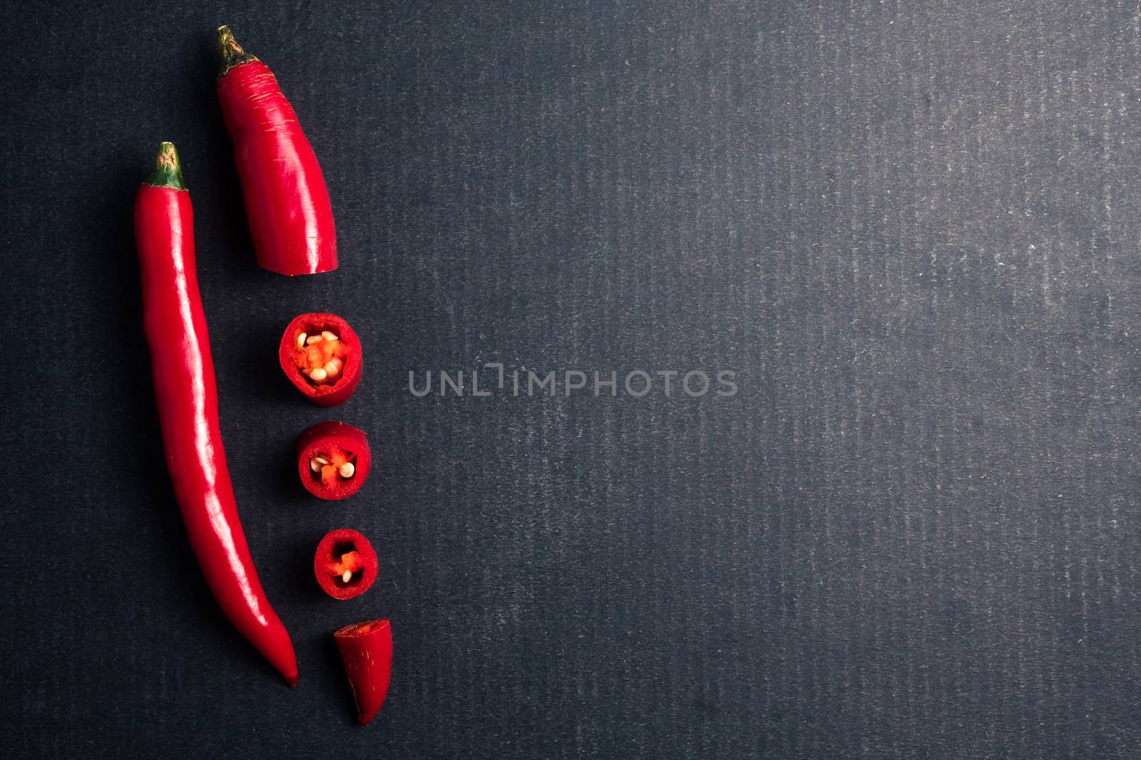 Fresh Red chili papper on black background. Free space for text by ronnarong