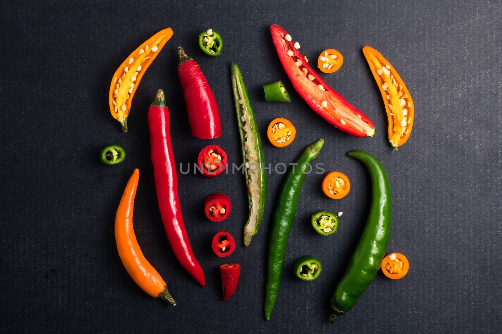 Colorful mix of chili pappers on black background.