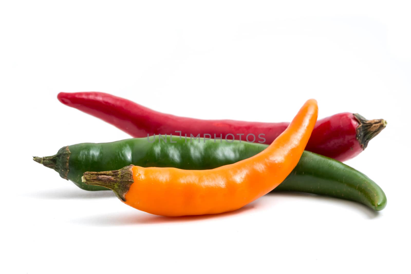 Colorful mix of chili pappers on white background.