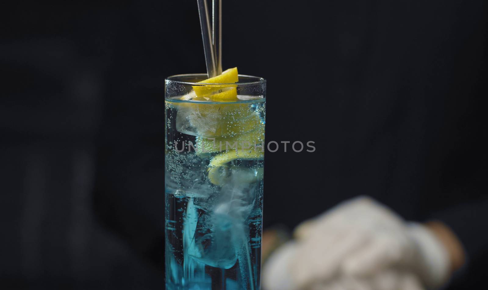 Close up glass of Blue Lagoon Cocktail on the table. Ready long drink. Bar drinks series