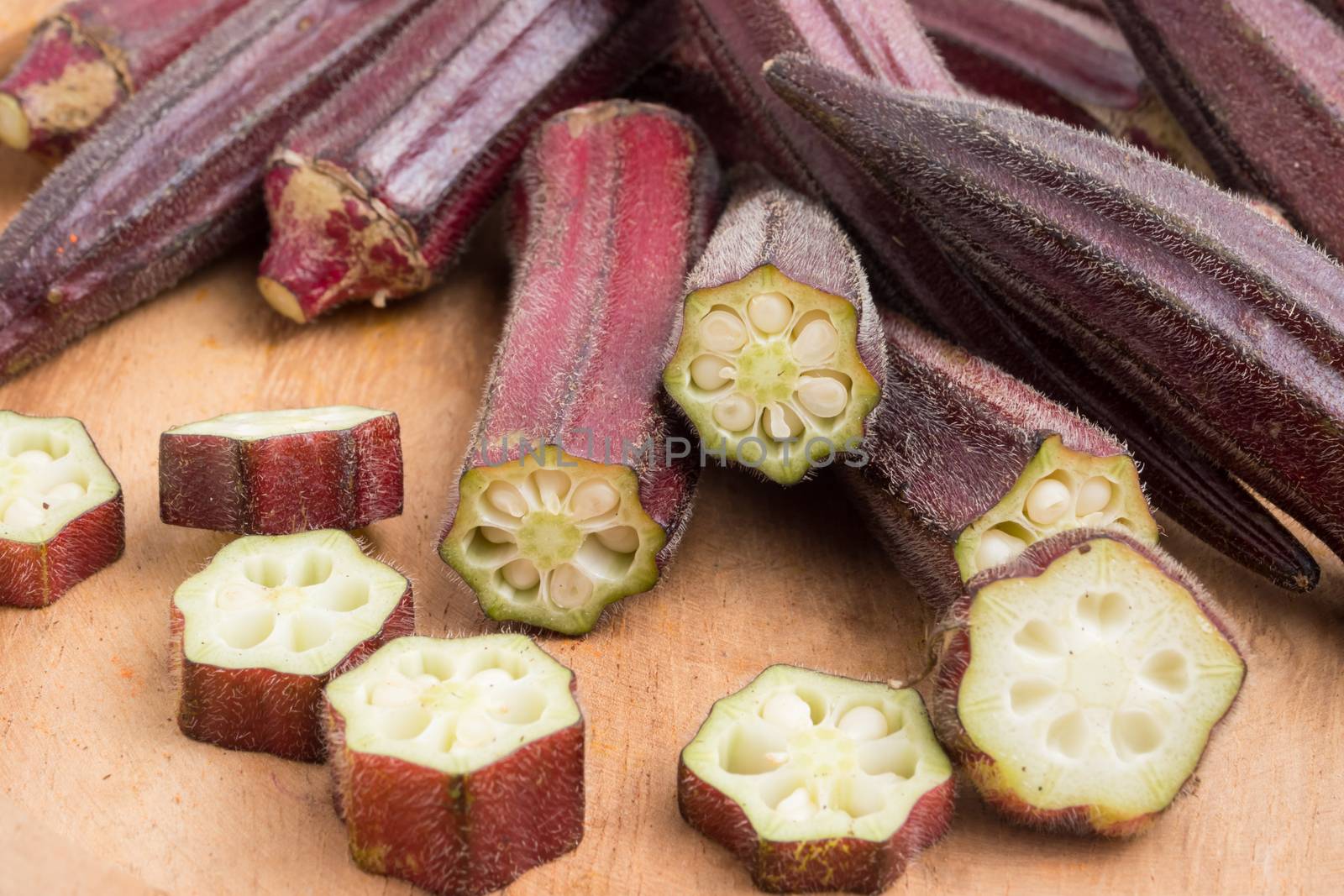 Fresh Red okra on wooden background. by ronnarong
