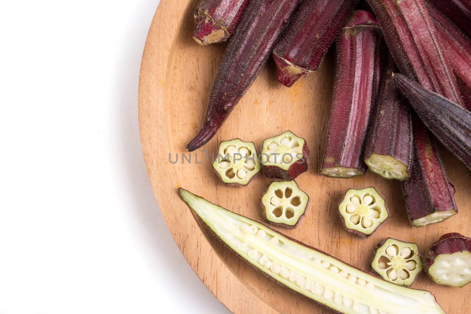 Fresh Red okra on tray over white background.