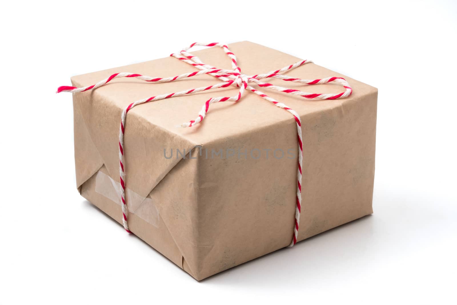 Gift package wrapped in brown paper on white background.