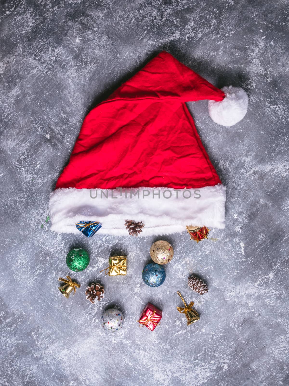 Top view of santa hat with christmas decoration on gray grunge background. by ronnarong