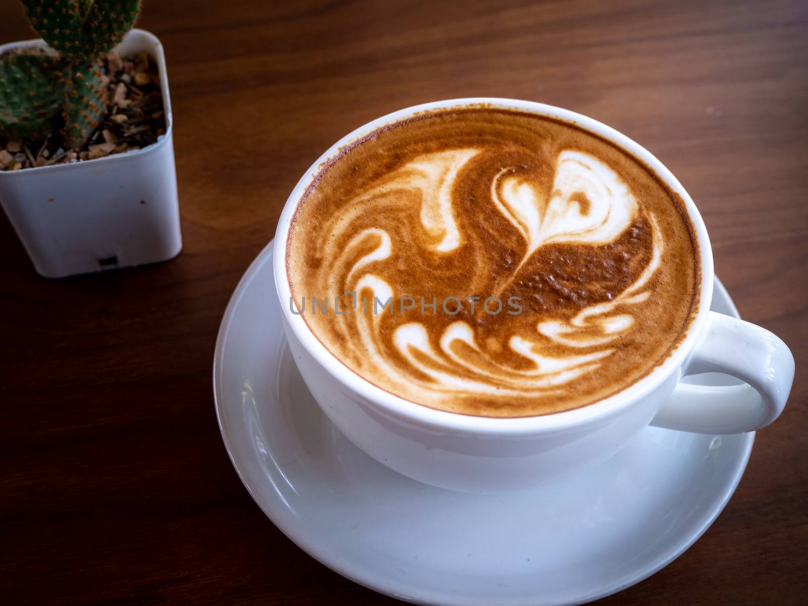 Coffee cup latte art on wood table