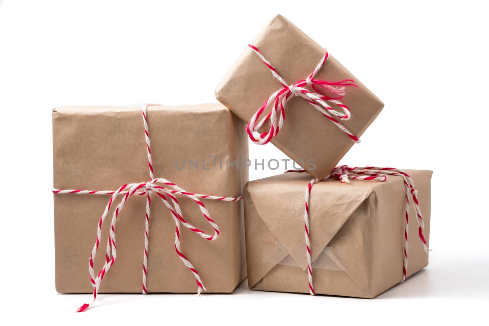 Gift packages wrapped in brown paper on white background. by ronnarong