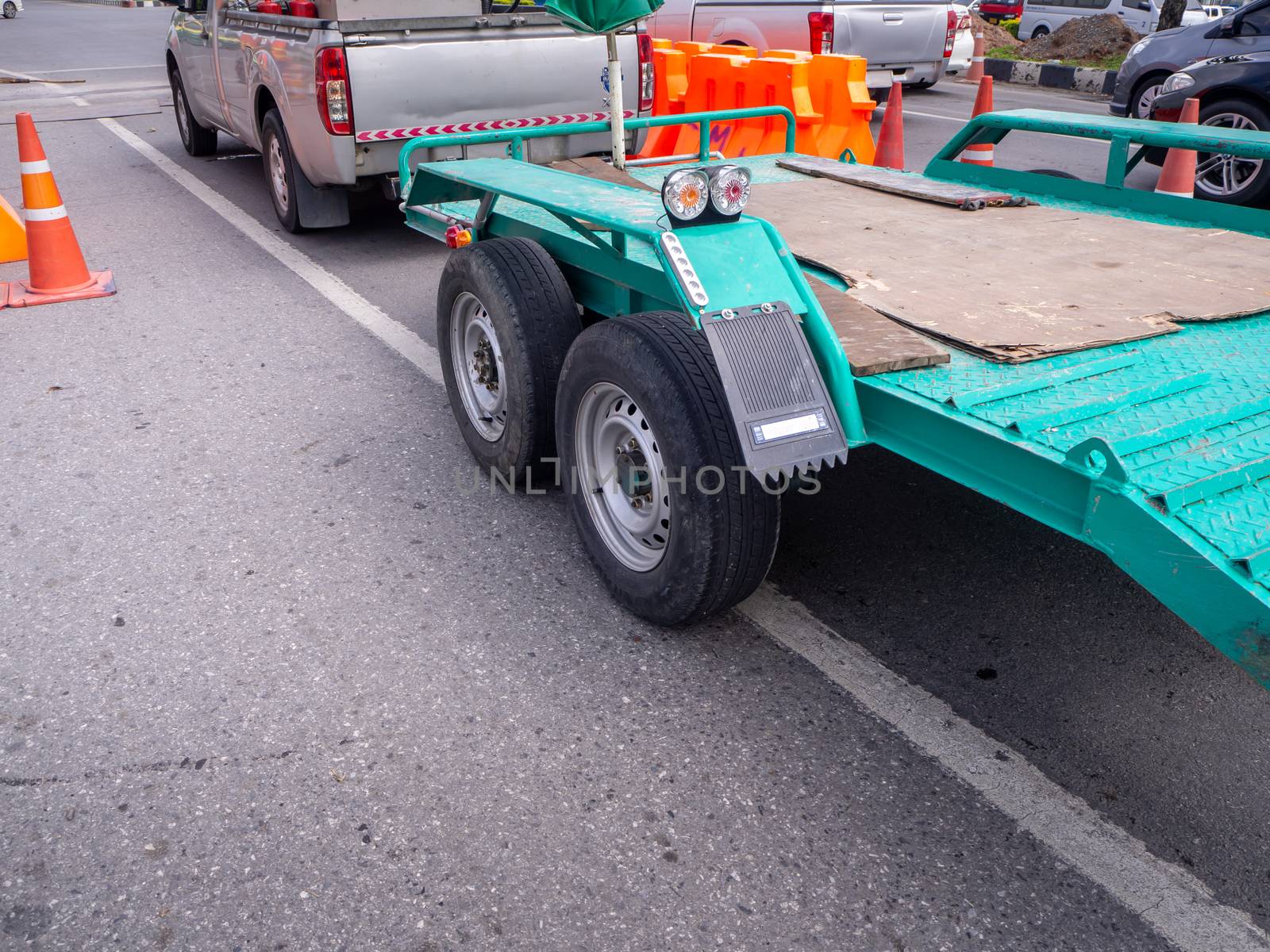 transporting small  cargo trailer for a car strapped on the road