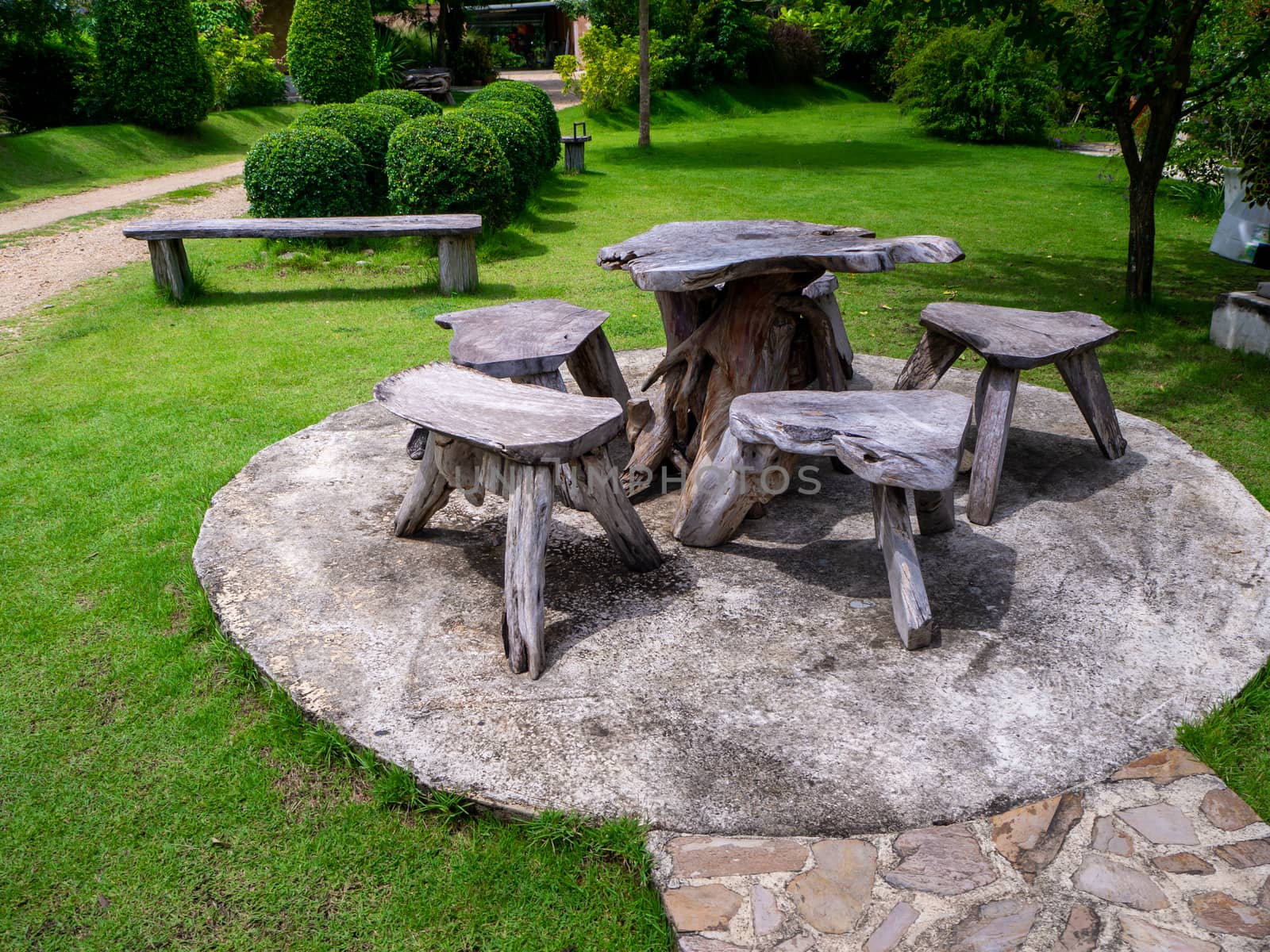 The Old wooden table set  in the green garden. by shutterbird
