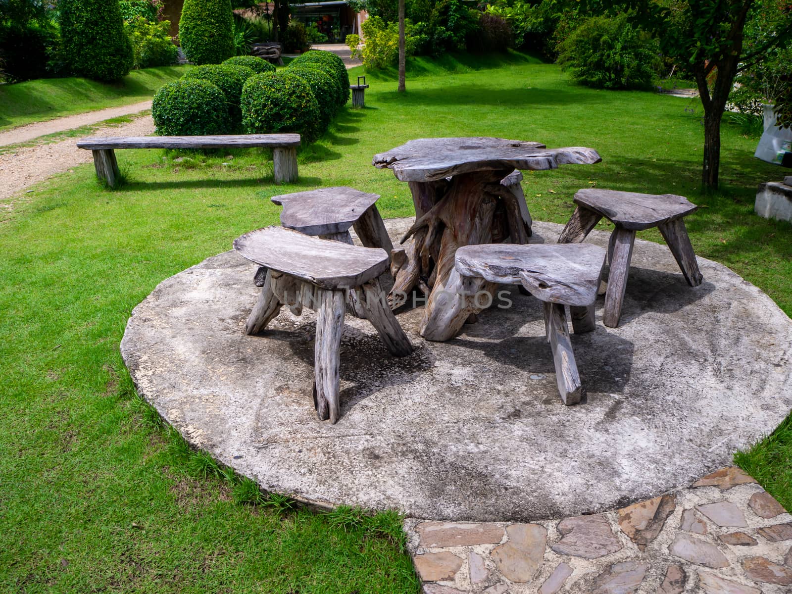 Old wooden table set  in the green garden.