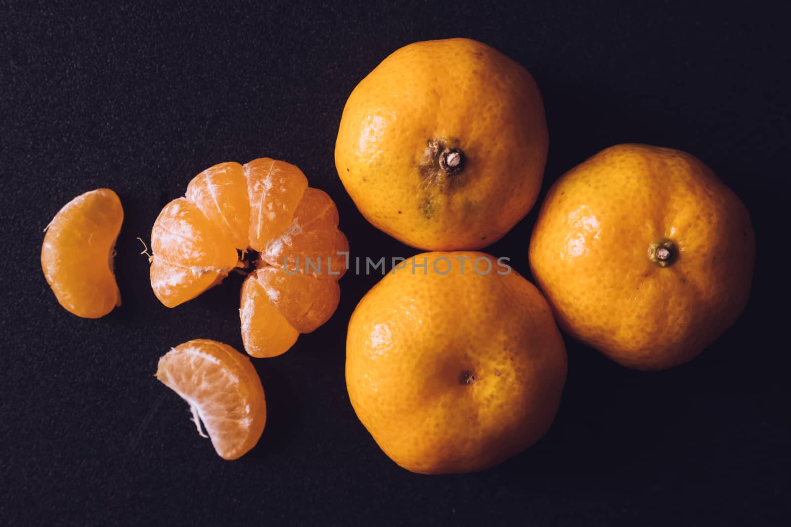 Close up of Fresh tangerines, Orange fruits on dark background. by ronnarong