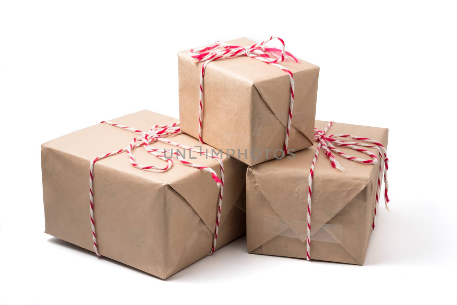 Gift packages wrapped in brown paper on white background.