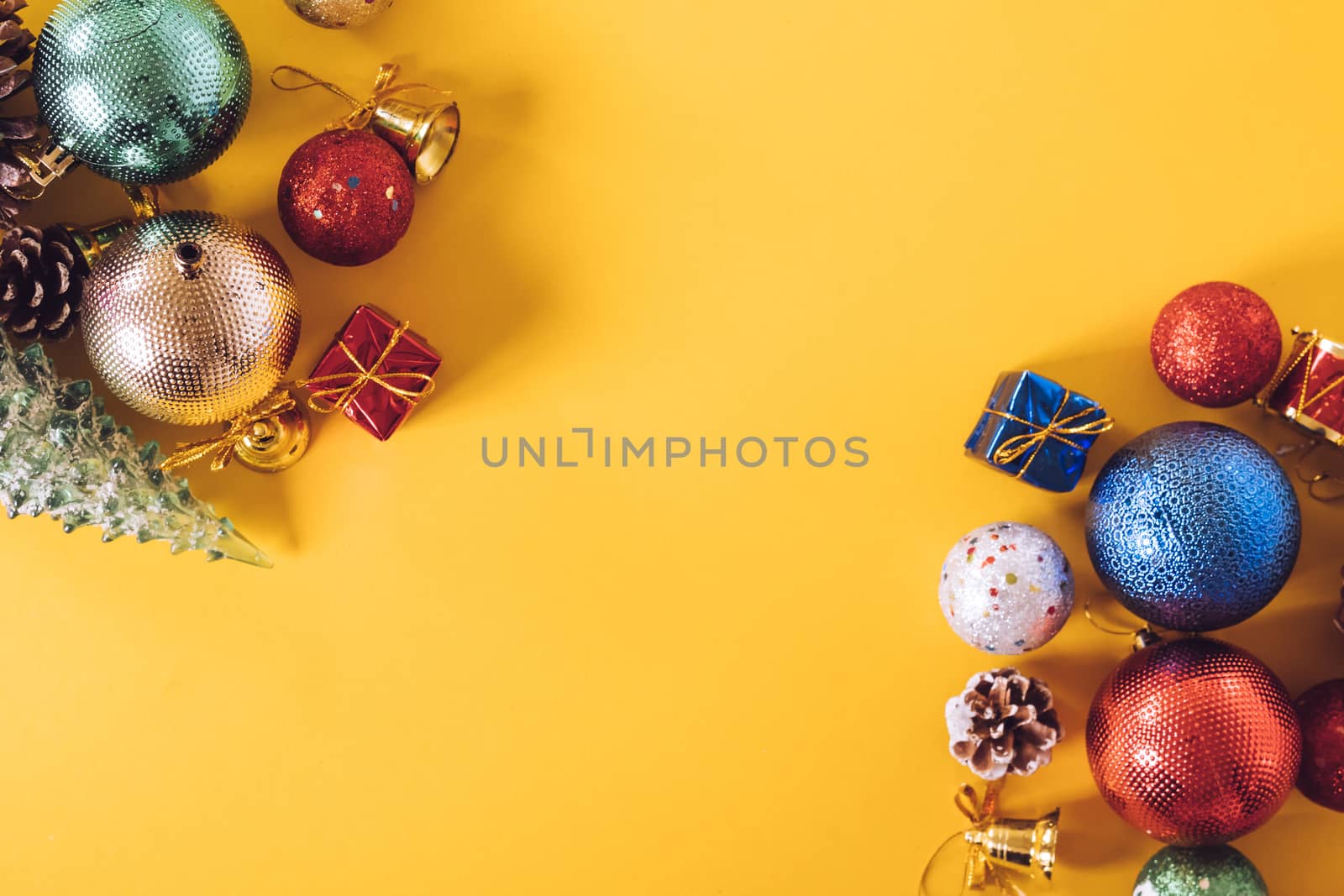 Top view of Christmas decorations on a yellow background. Free space for text