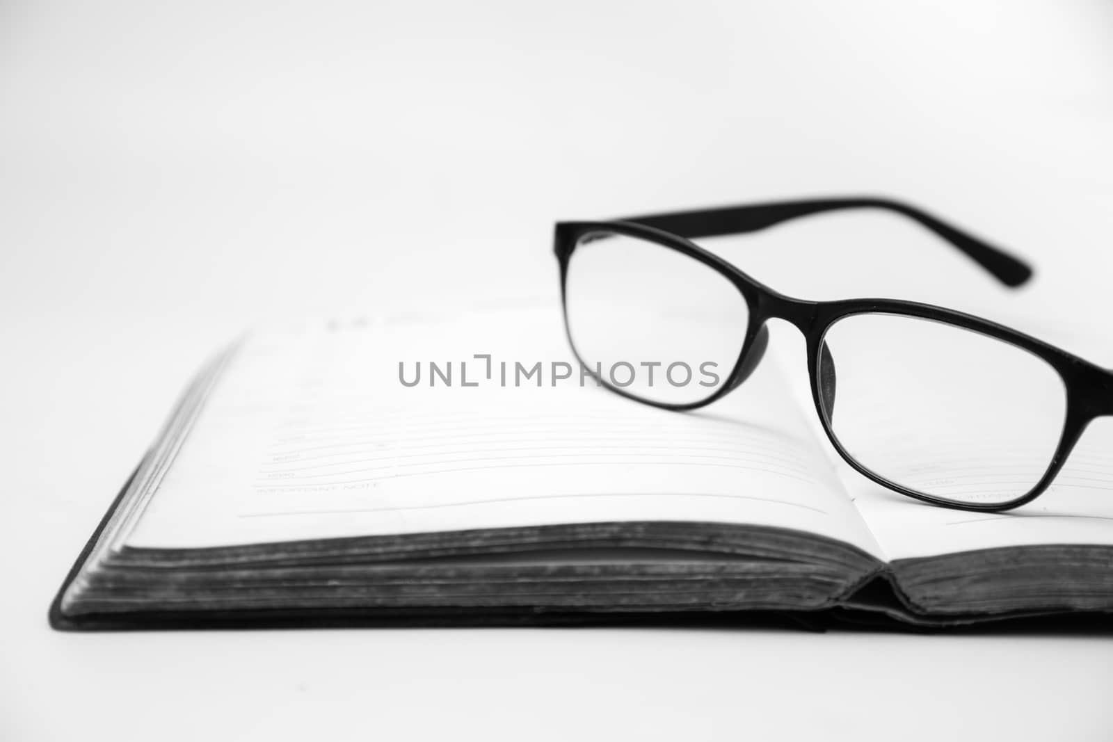 Eyeglasses on an open book, Black and White tone by ronnarong