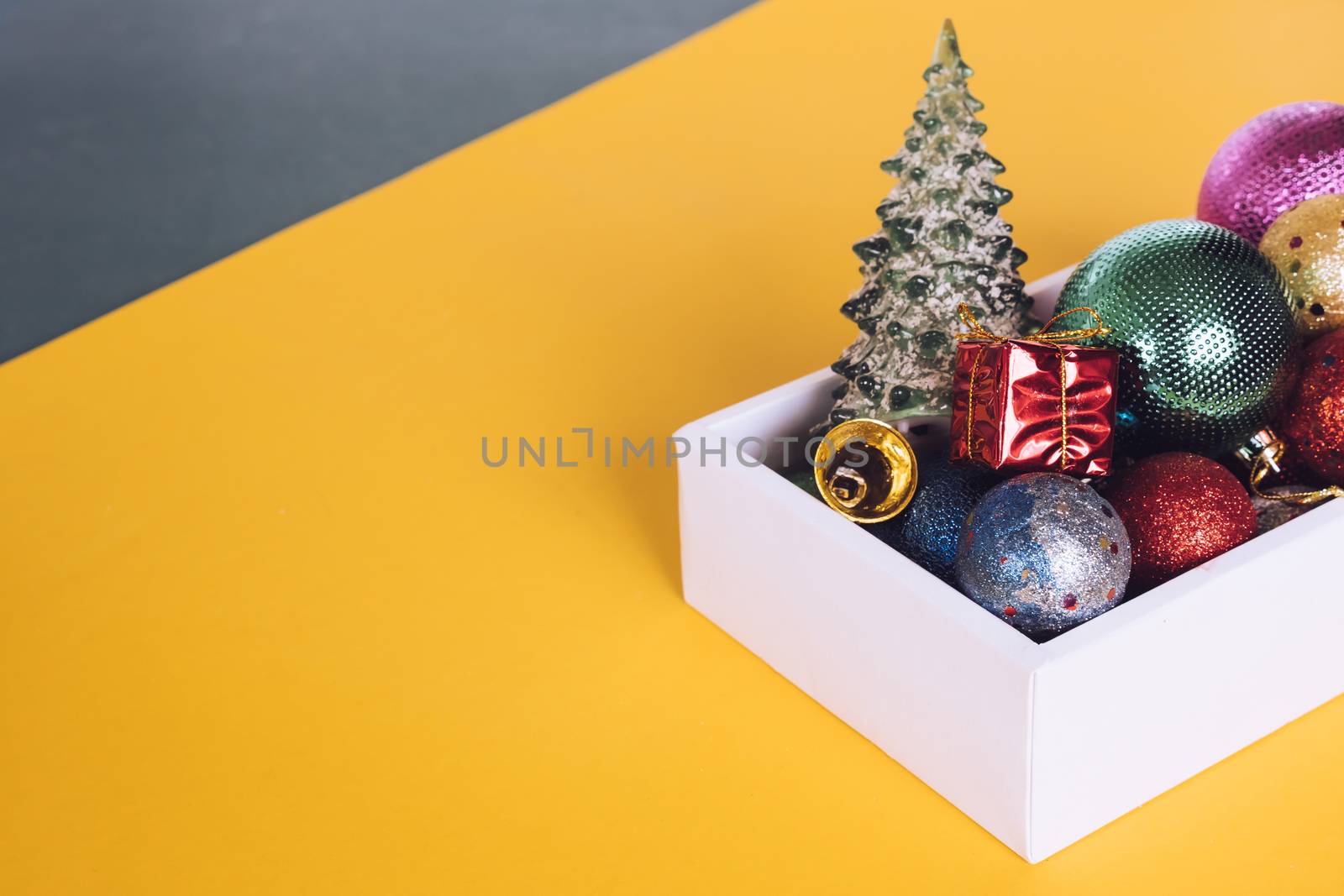 Christmas decorations in white box on colorful background. by ronnarong
