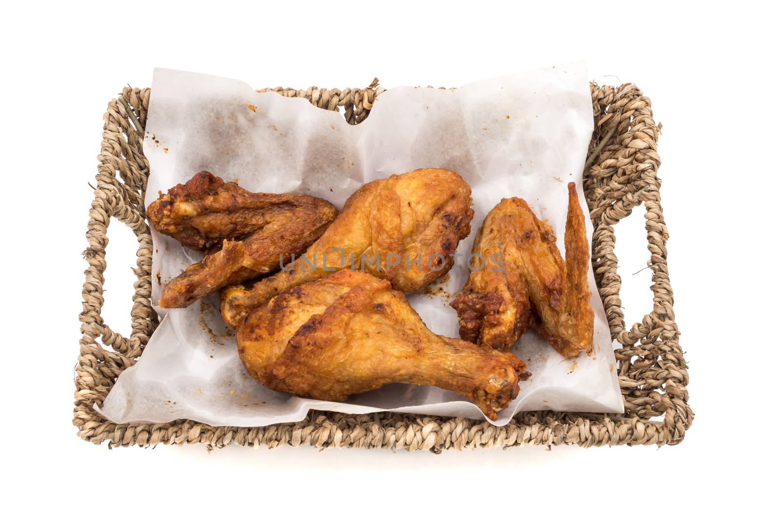 Fried chicken legs and wings in basket on a white background. by ronnarong