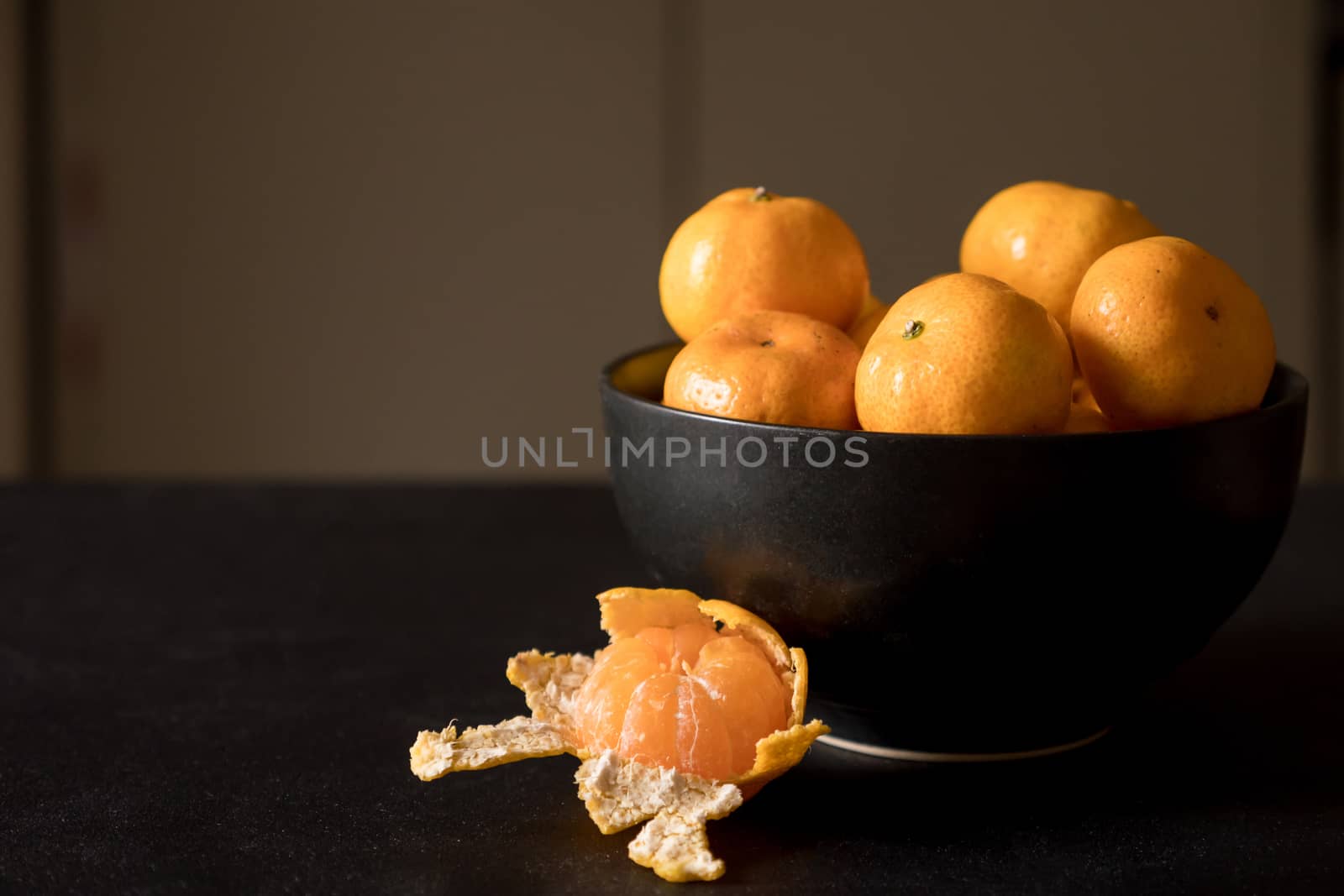 Fresh tangerines in bowl, Orange fruits on dark background. by ronnarong