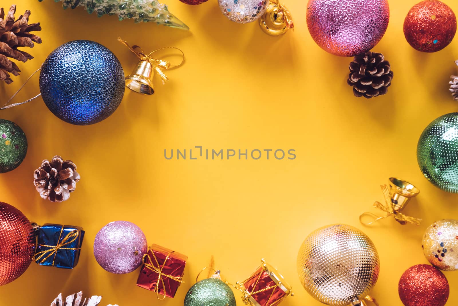 Top view of Christmas decorations on a yellow background. Free space for text