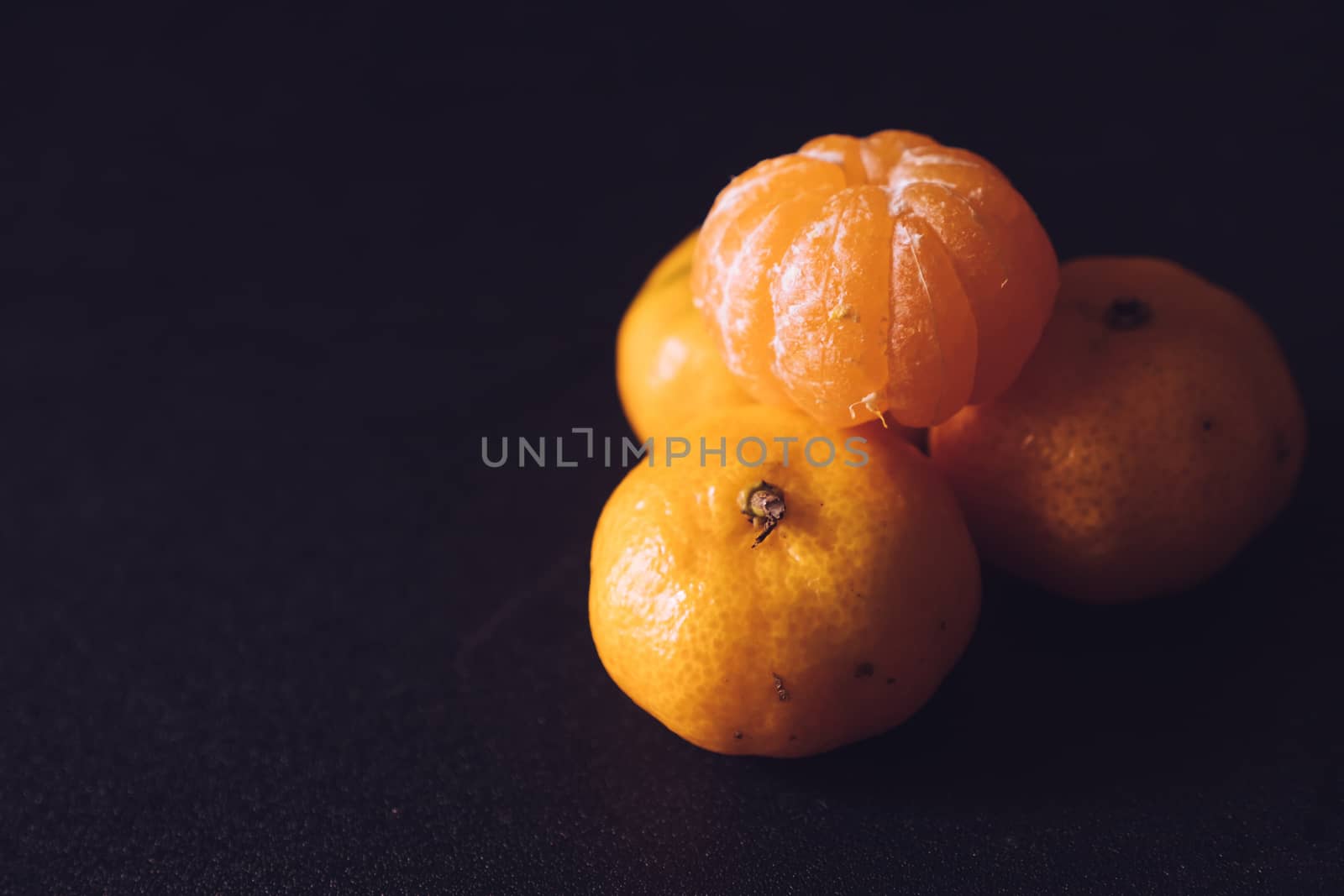 Close up of Fresh tangerines, Orange fruits on dark background. by ronnarong