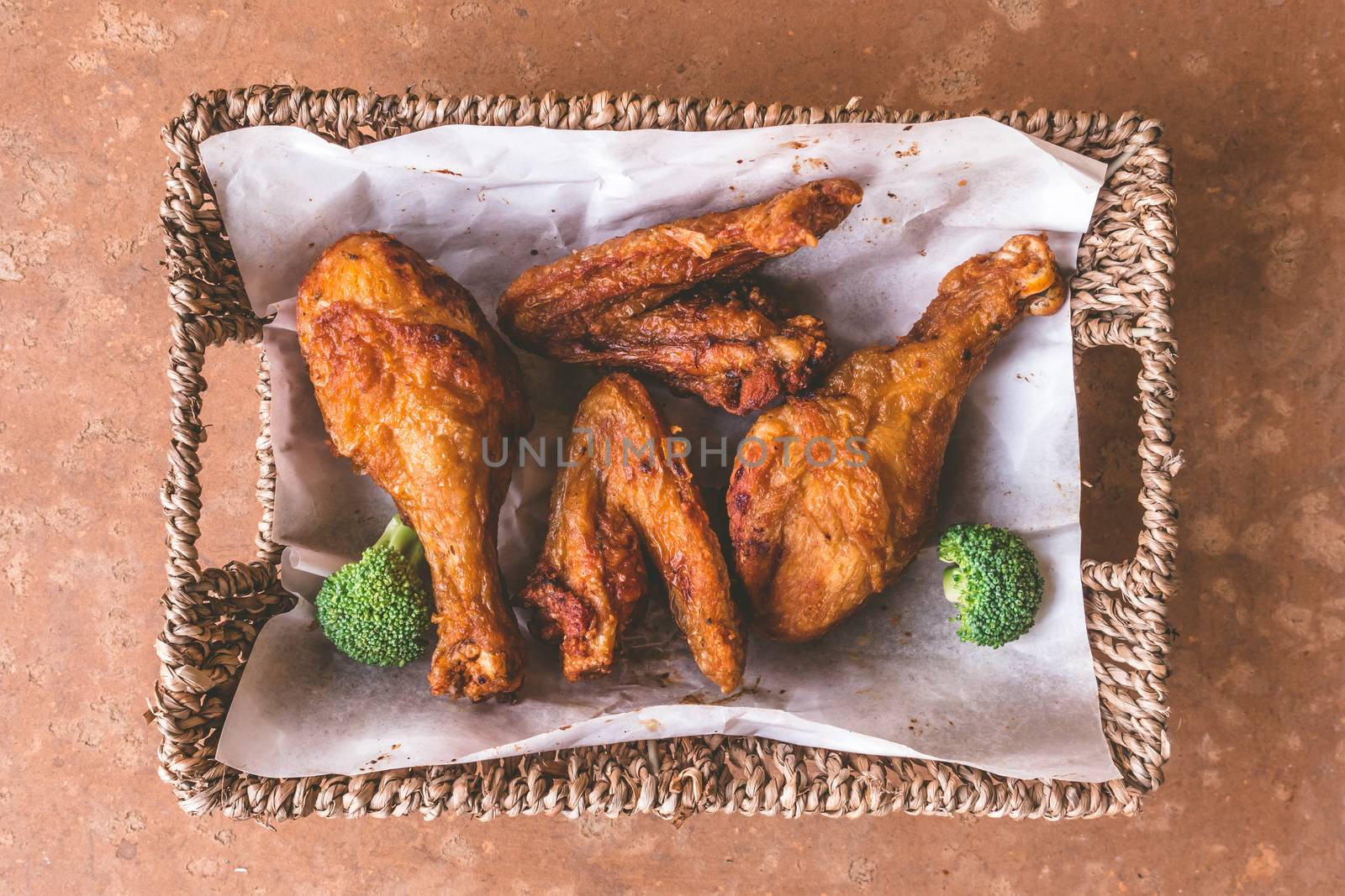 Top view of Fried chicken legs and wings in basket.  by ronnarong