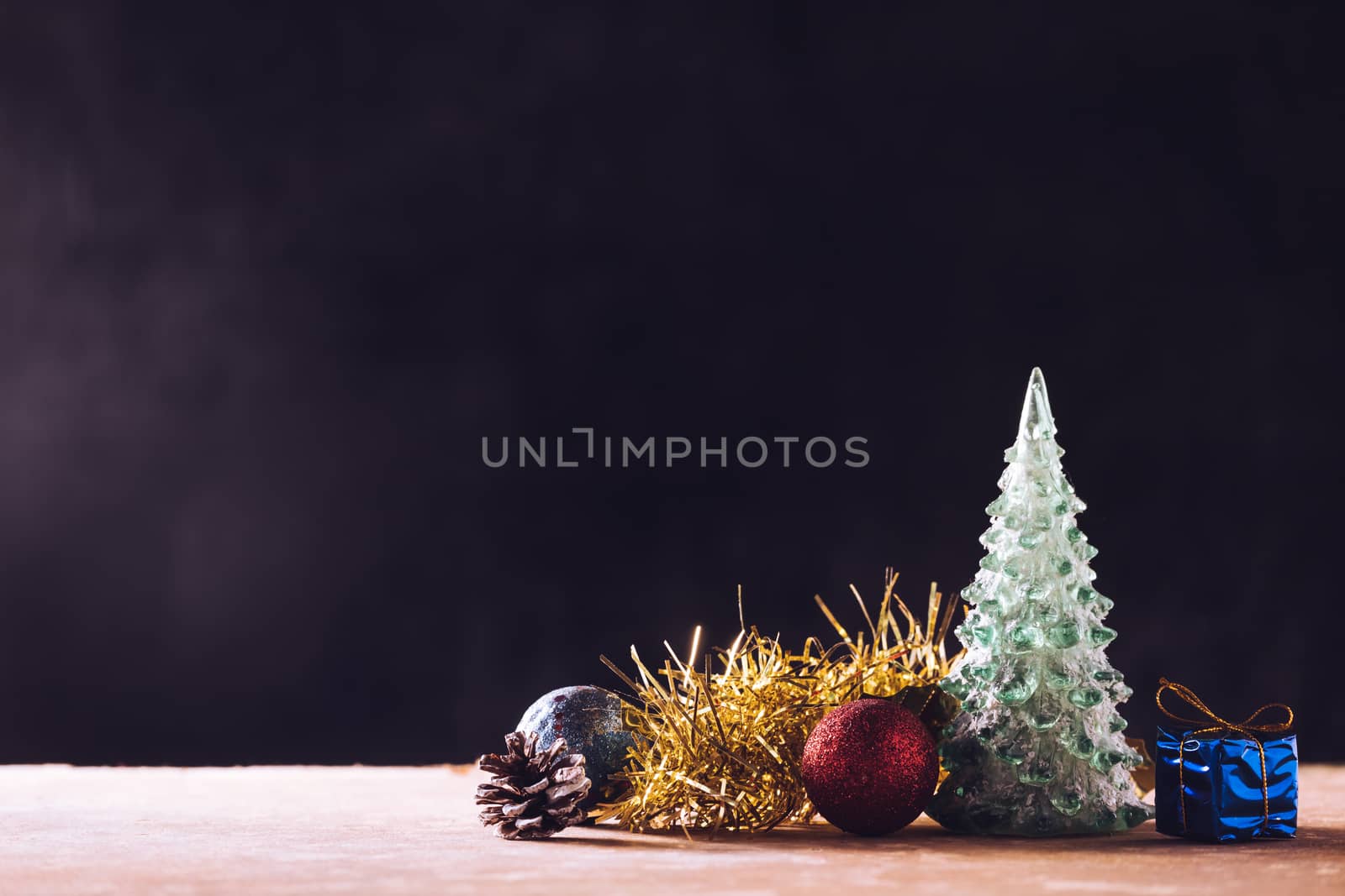Christmas decorations on the wooden table, black background, free space for text
