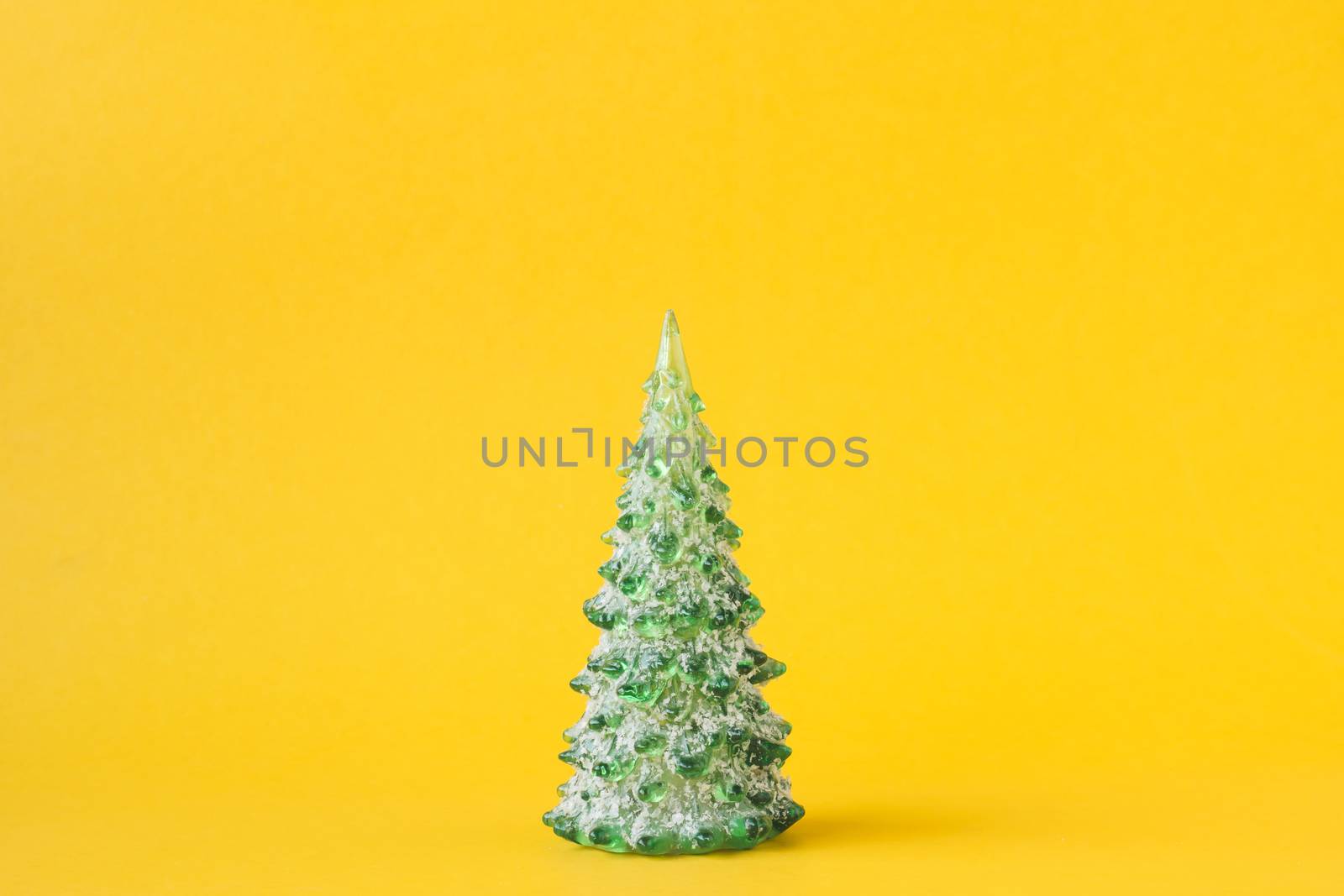 Christmas decoration with pine tree on yellow background. by ronnarong