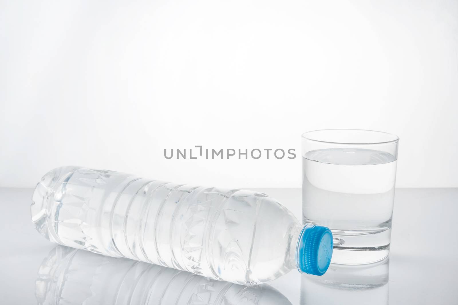 water in plastic bottle with glass