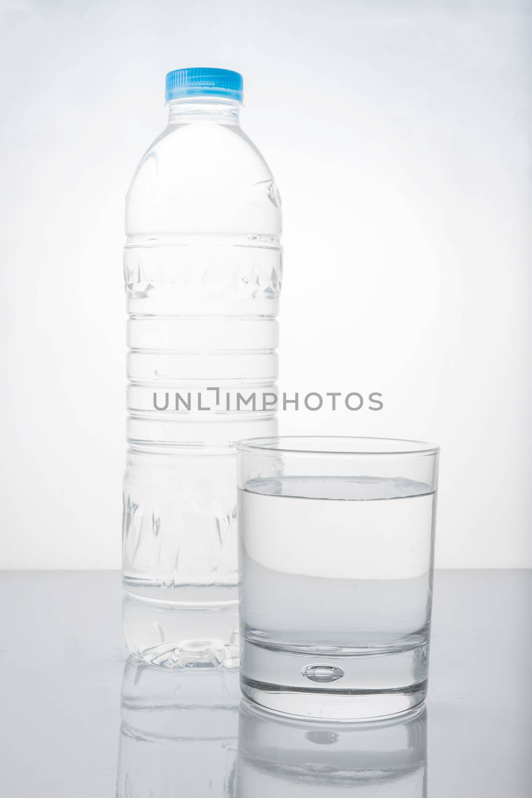 water in plastic bottle with glass