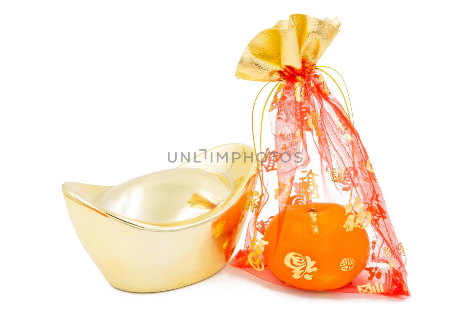 concept image of the chinese new year - Gold Ingot and mandarin orange in the red auspicious bag