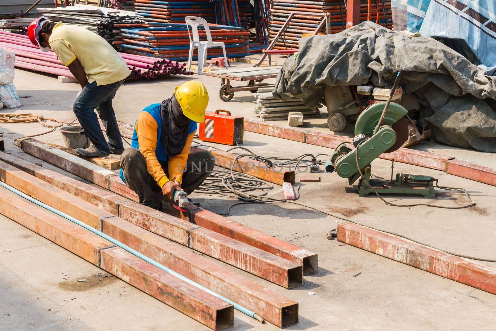 Steel Workers welding, grinding, cutting in metal industry by ronnarong