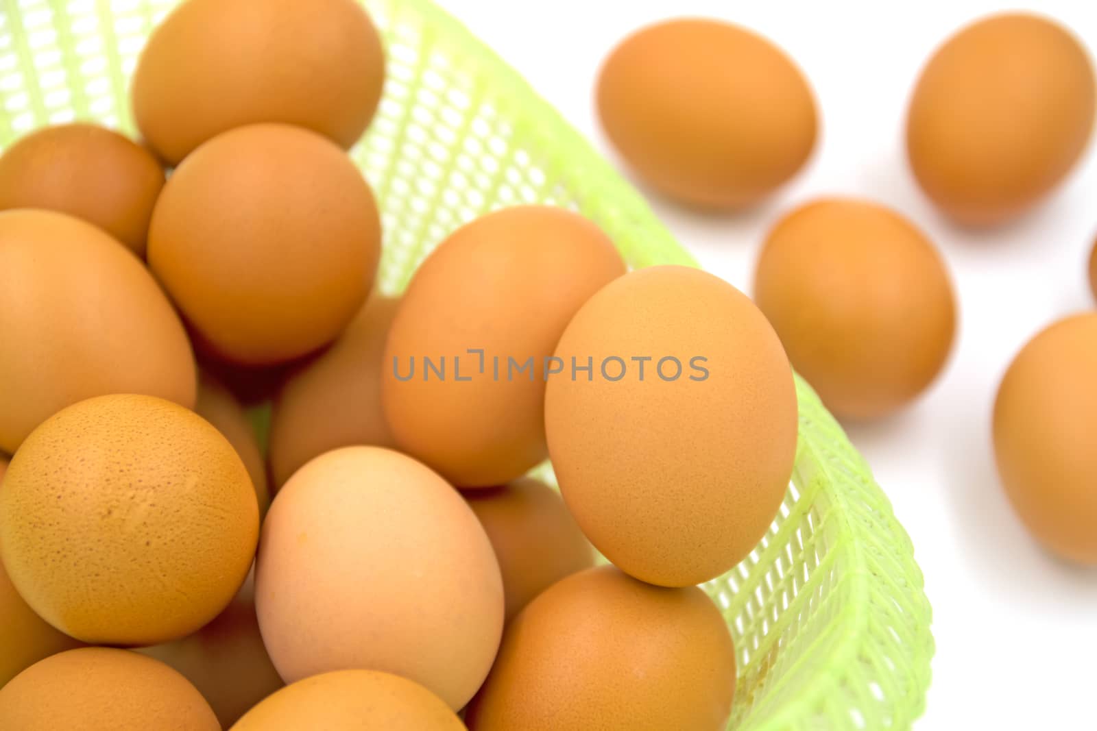 Eggs in basket isolated on white background.Selective focus
