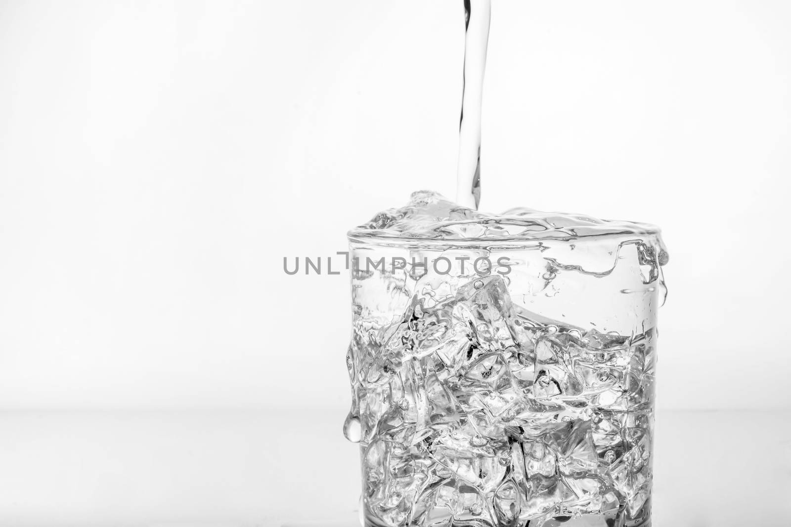 glass with ice and splashing water by ronnarong