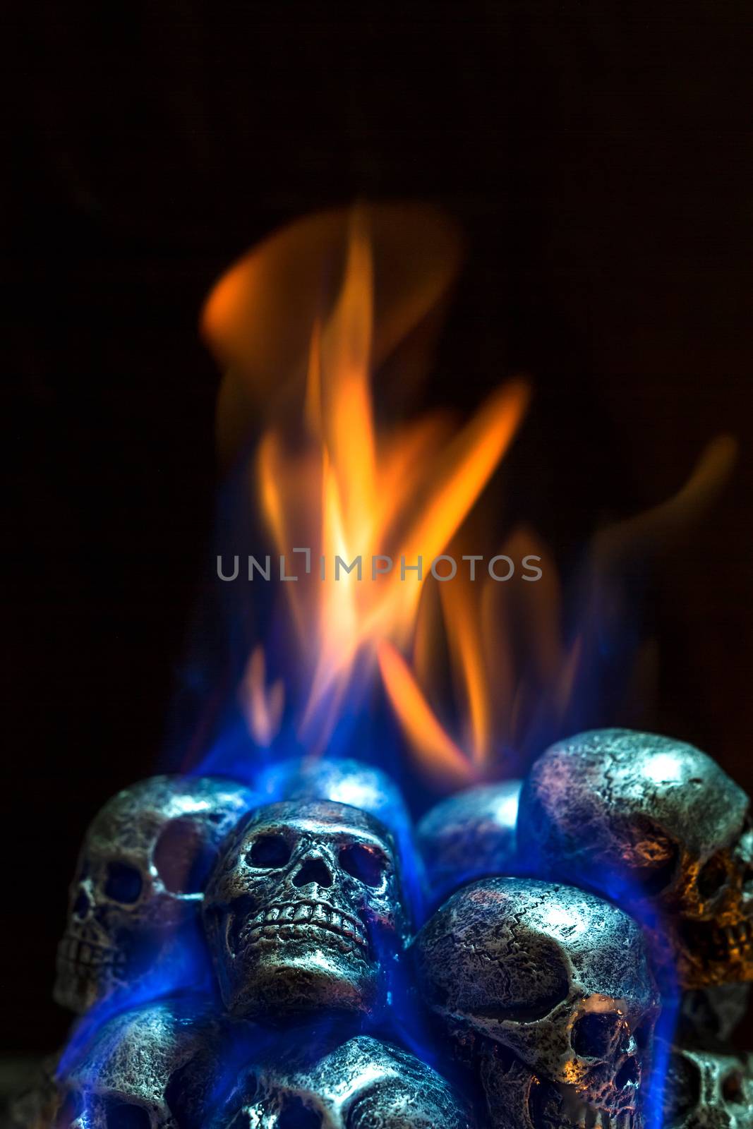 Burning skulls on black background