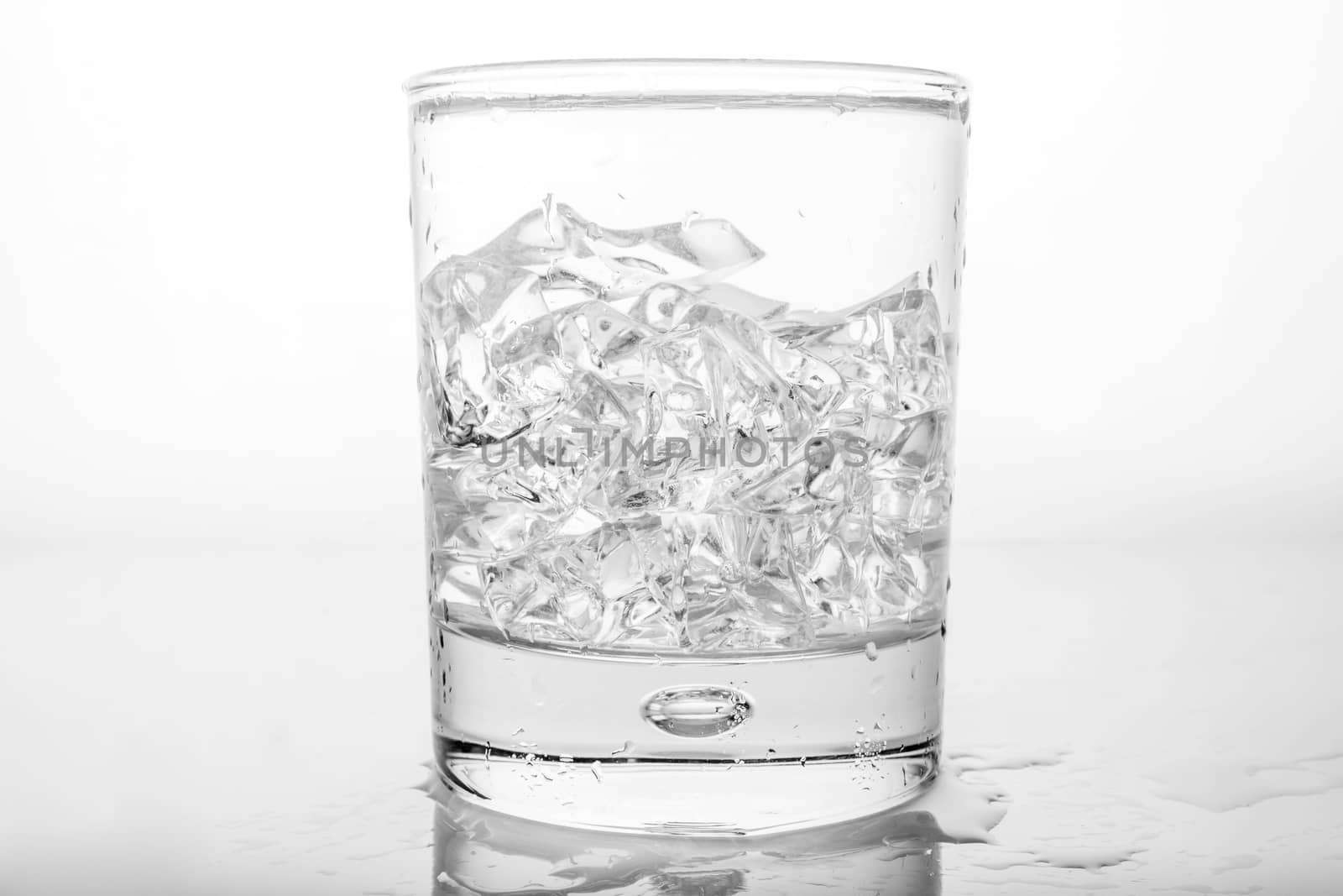 Glass of pure water with ice cubes.