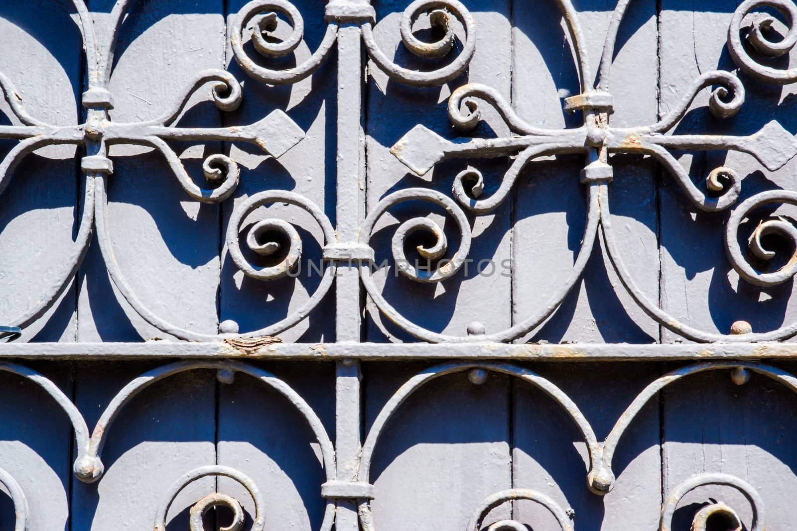 grey old stained wood with wrought iron design