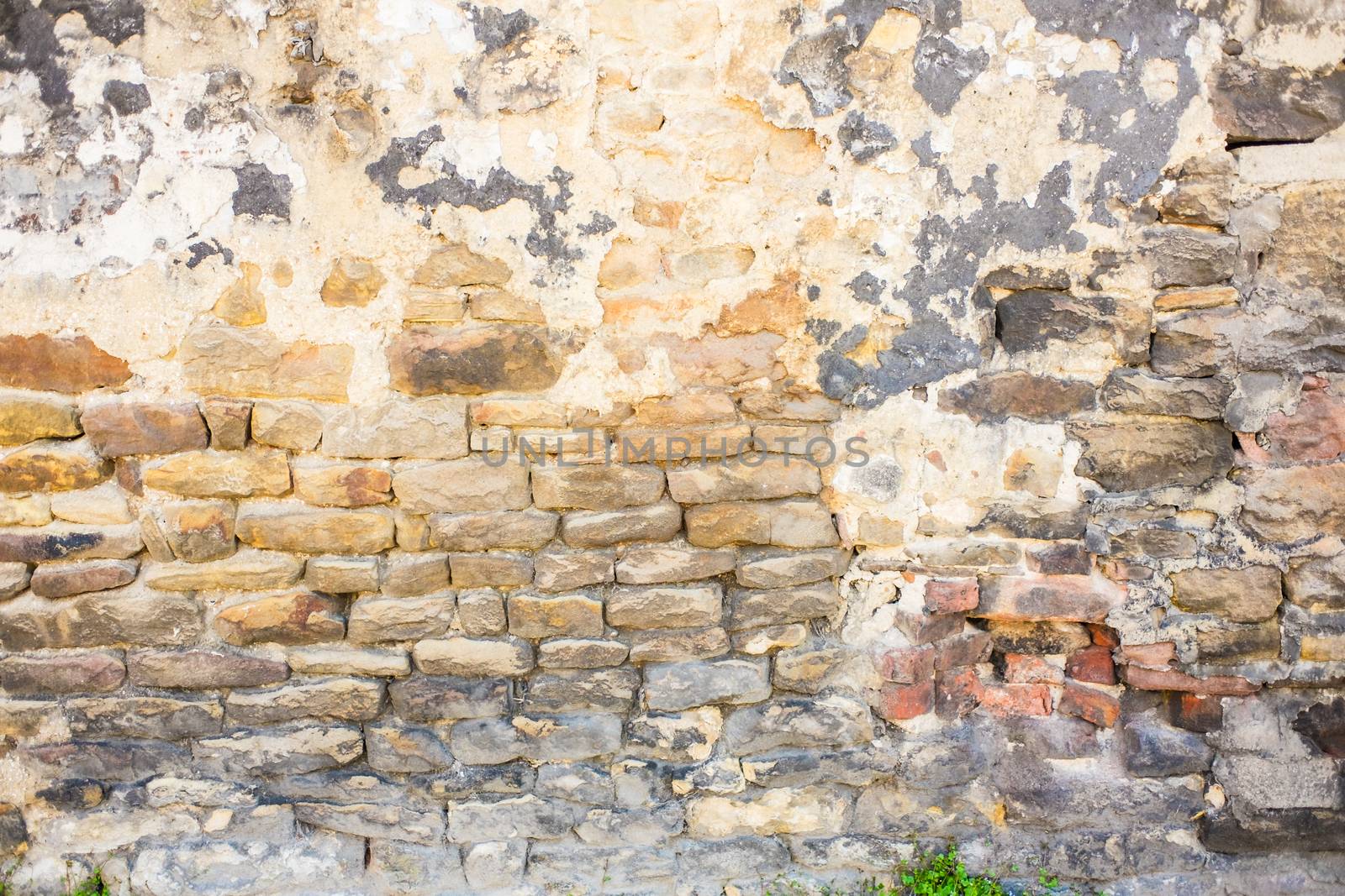 Detail shot of an old brick wall and crumbling cement UK