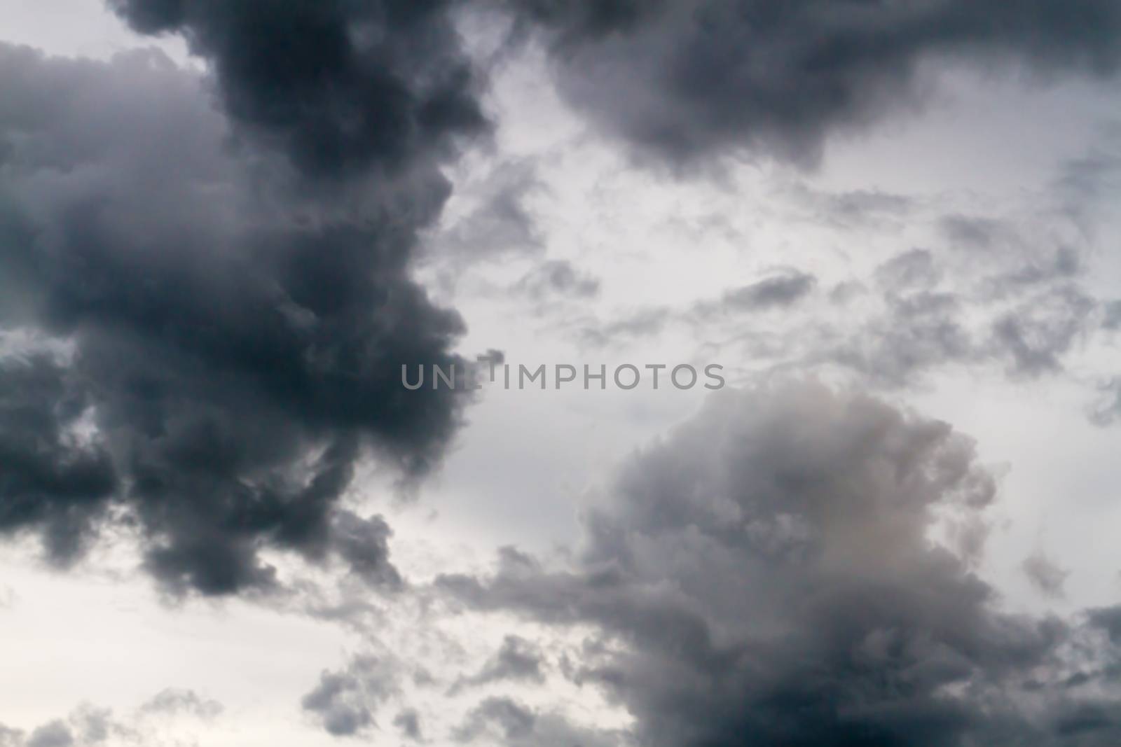 Dramatic and dark sky with storm clouds.Blur or Defocus image by ronnarong