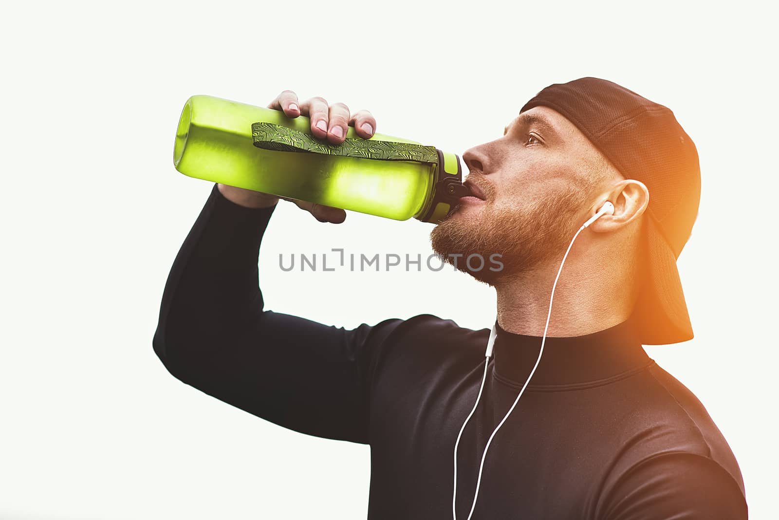 Close-up Shot Bearded Sportive Man take a rest and drink a water After Workout Session.