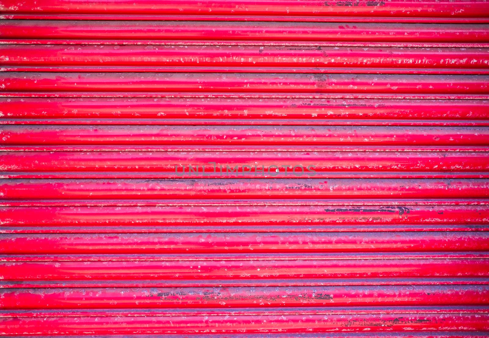 red roller shutter on the door of closed retail premises
