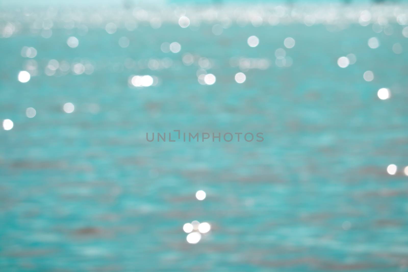 Blur reflection of sunlight on blue sea water surface