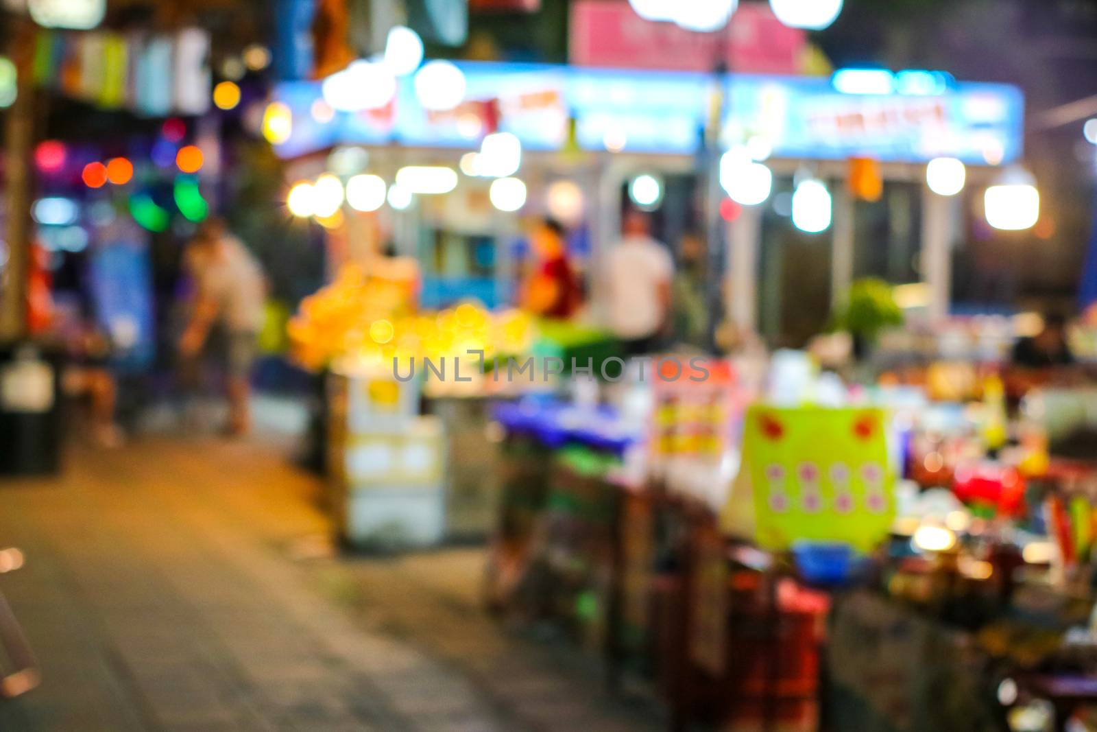 blurred colorful light street food of china town at local market in pattya city
