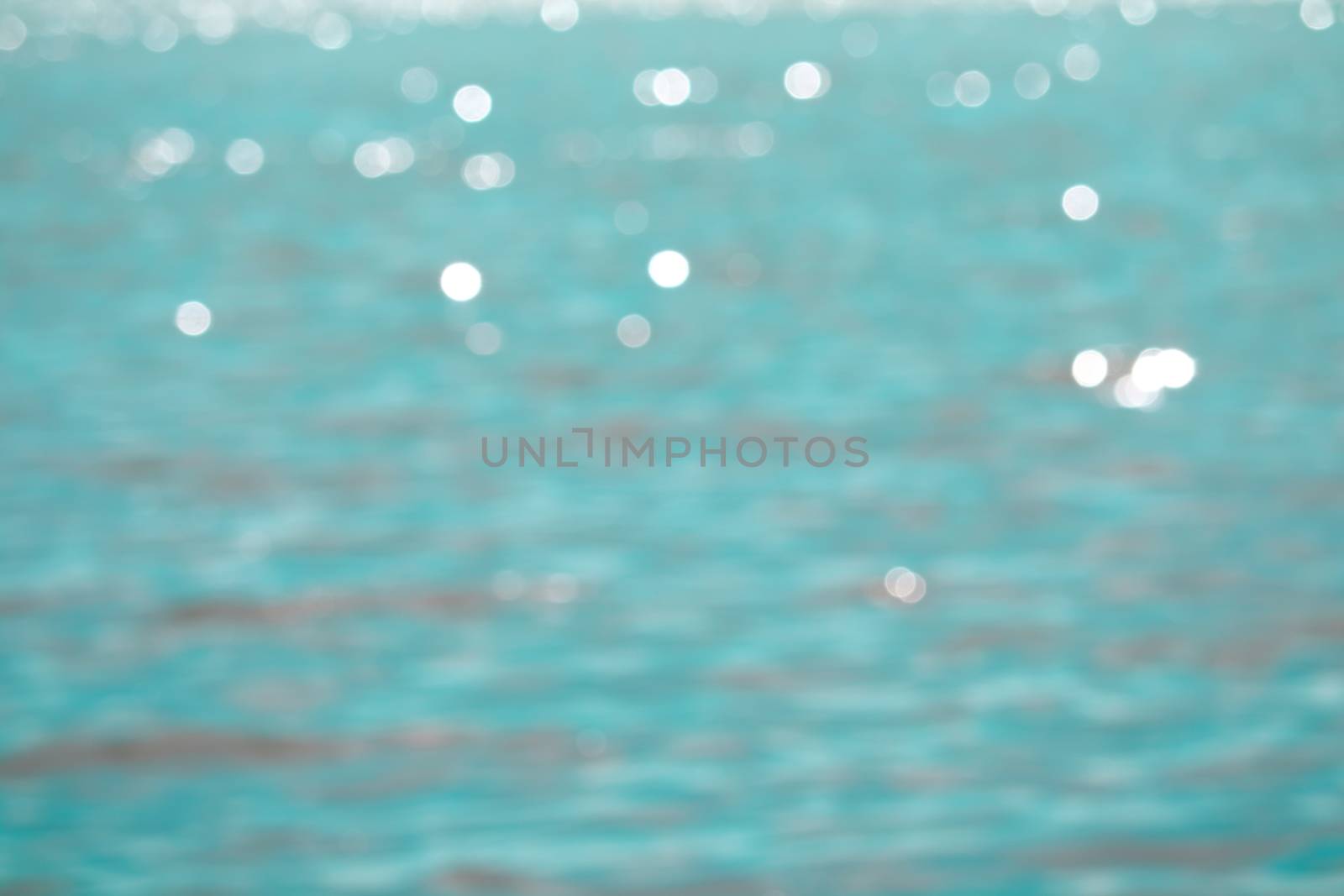 Blur reflection of sunlight on blue sea water surface