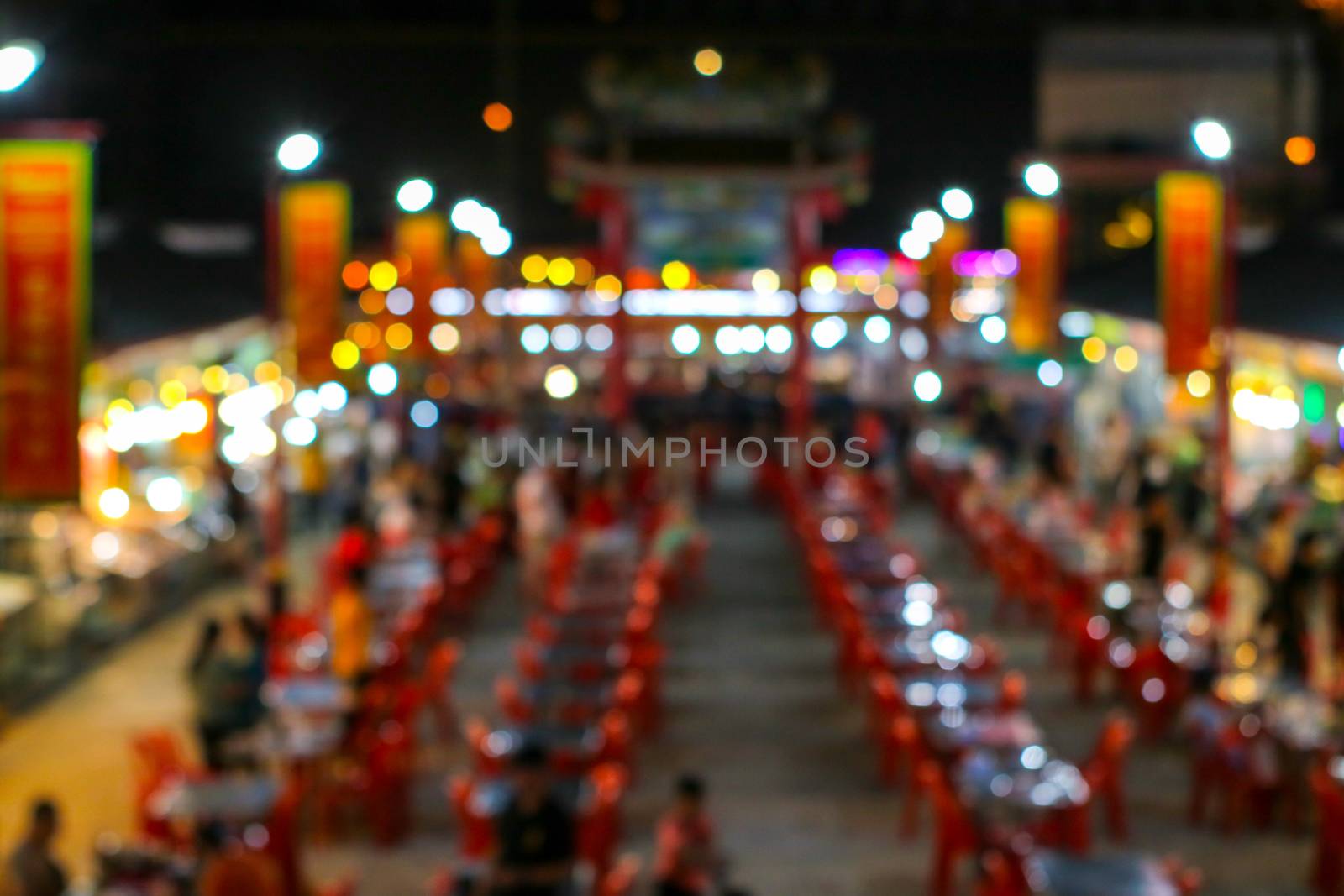 blurred colorful light image of china town restuarest and local market in pattya city