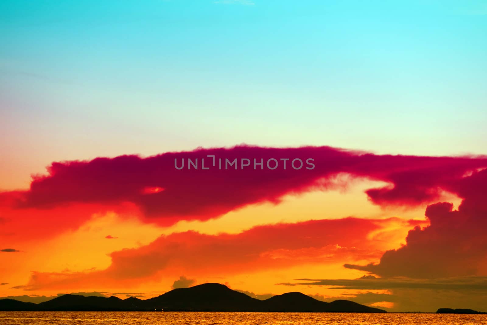 sunset on the sea and colorful flame cloud cold sky silhouette island